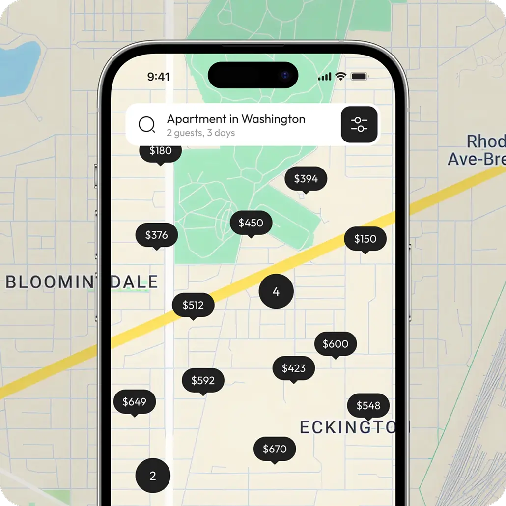 Phone showing the app map with priced property pins across a neighborhood.