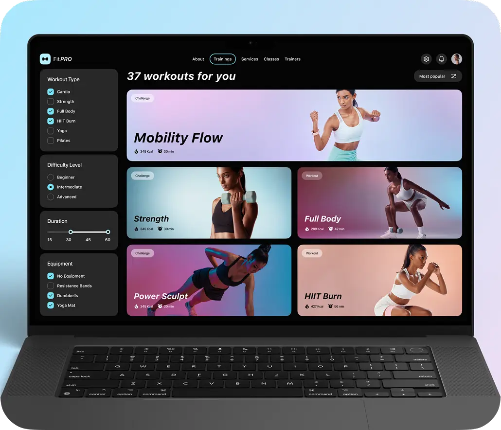 Laptop displaying the fitness app web version with workouts.