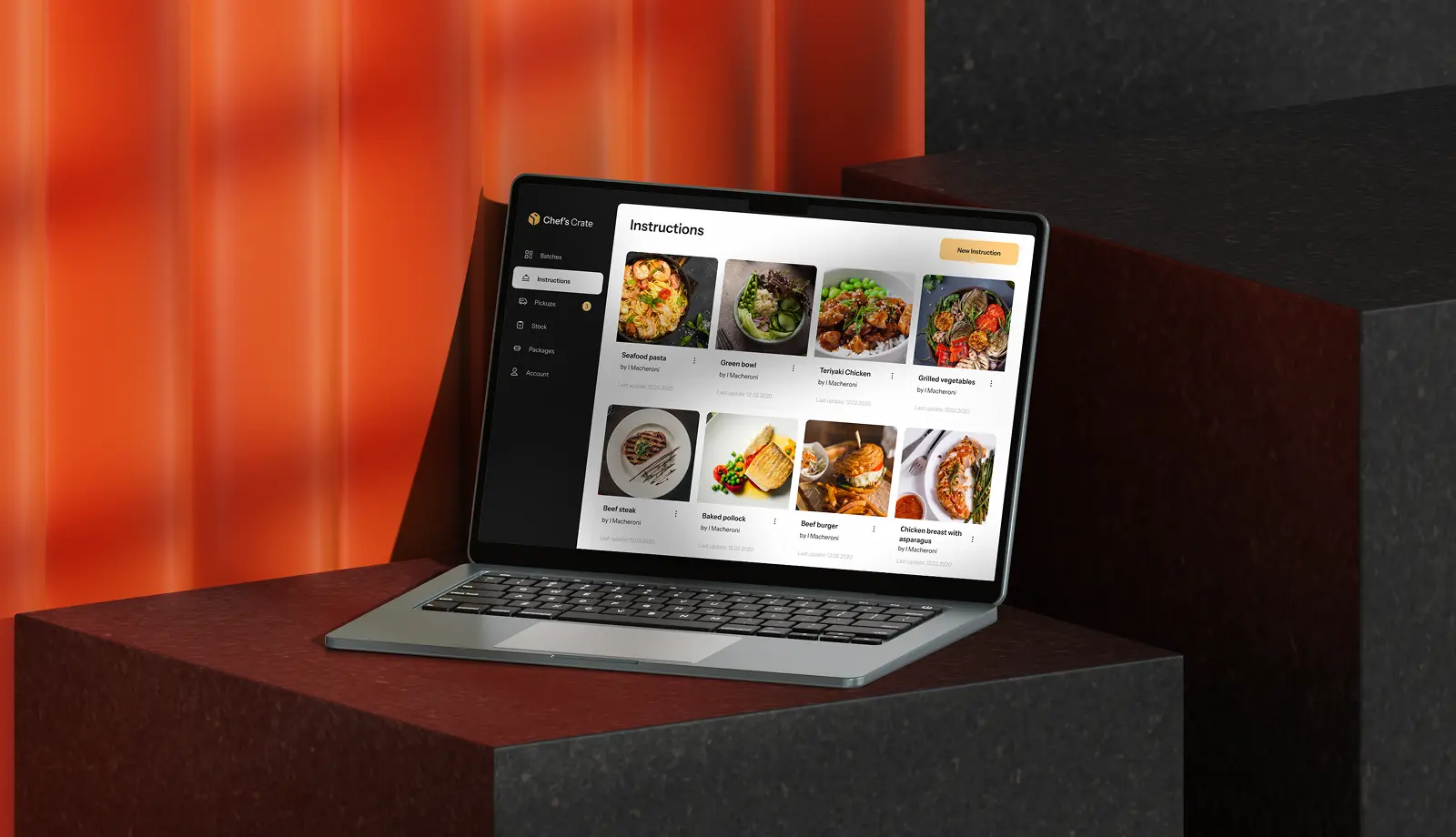 Laptop on a dark pedestal against an orange backdrop, showing the Chef's Crate Instructions screen.