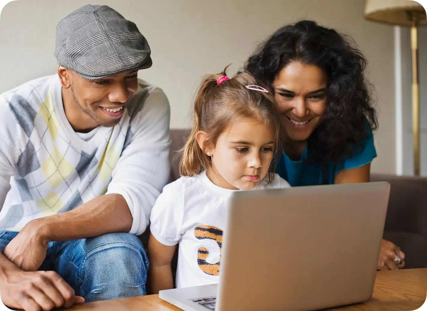 Family learners studying together on a laptop at home.