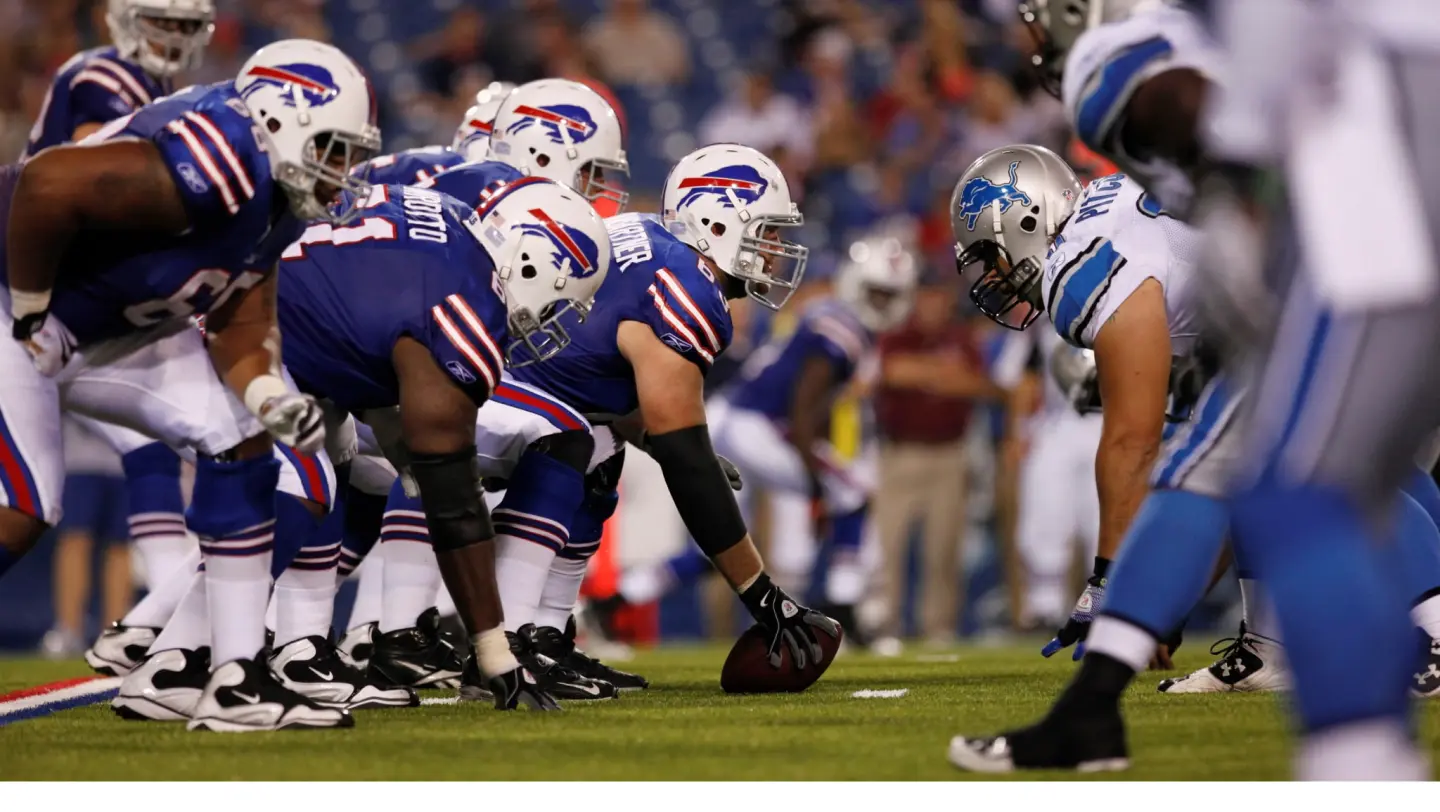 Photo of American football players in action during a game.