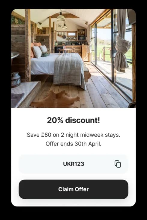 UK Retreats app card offering a 20% discount on a holiday stay, with a promo code and a Claim Offer button.