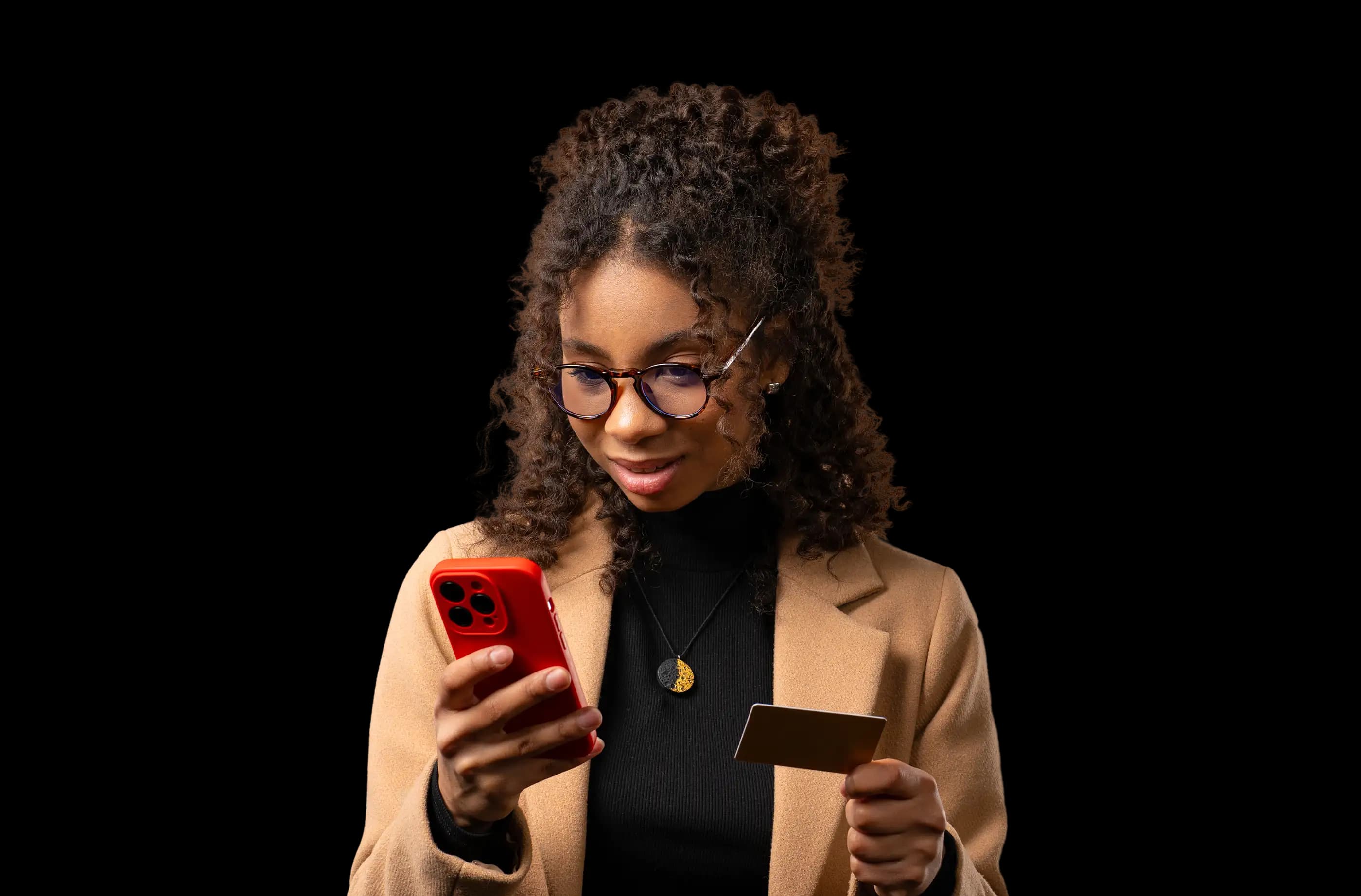Woman using the neobank app on her phone in a dark setting.
