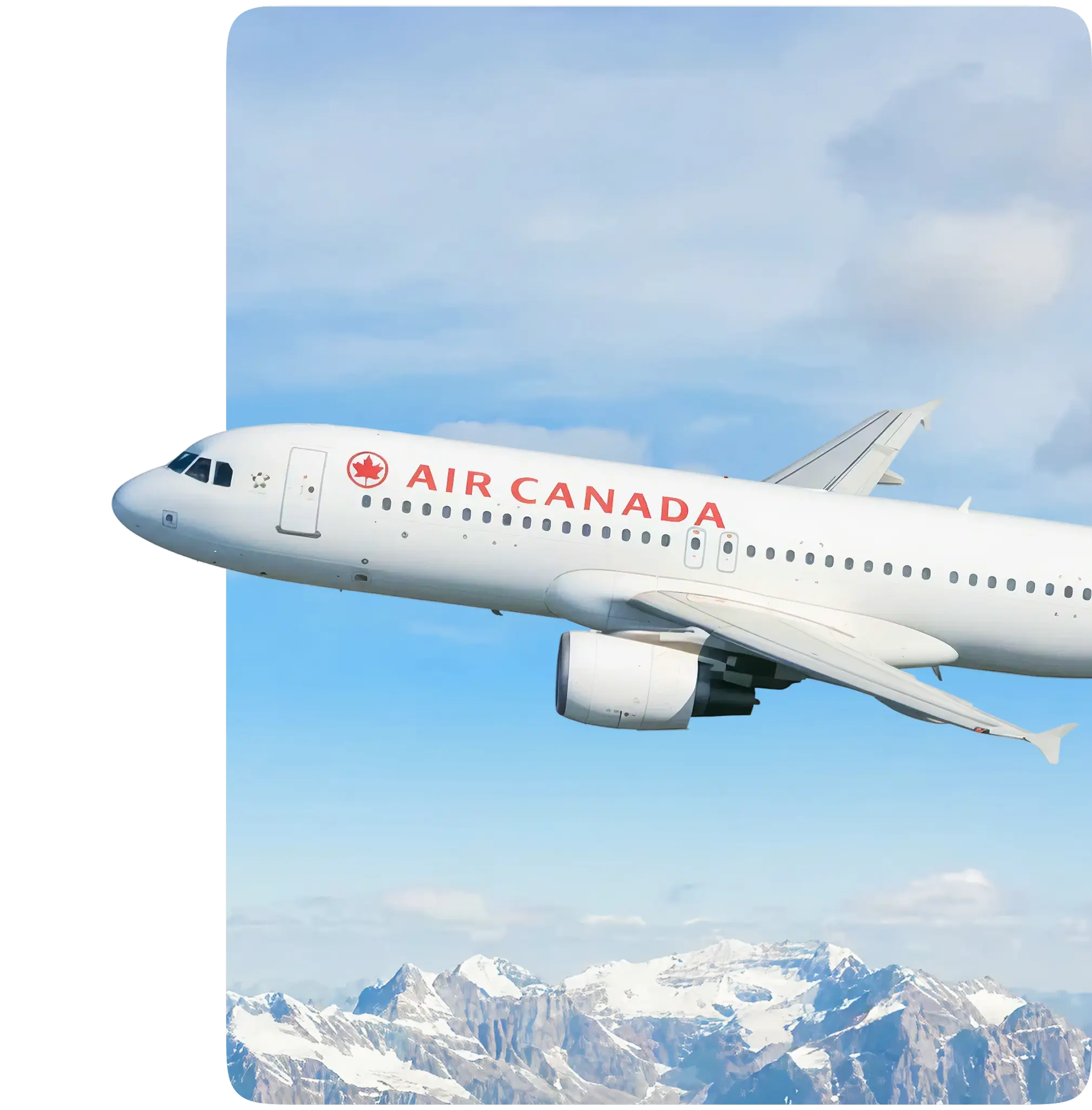 Passenger plane flying above snow-capped mountains.